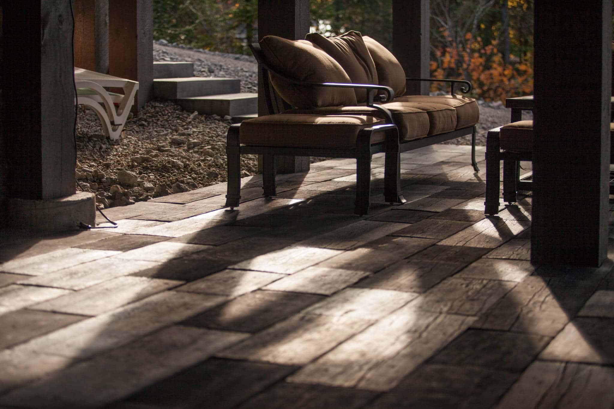 Detail of brick patio, with outdoor furniture, at cabin property.