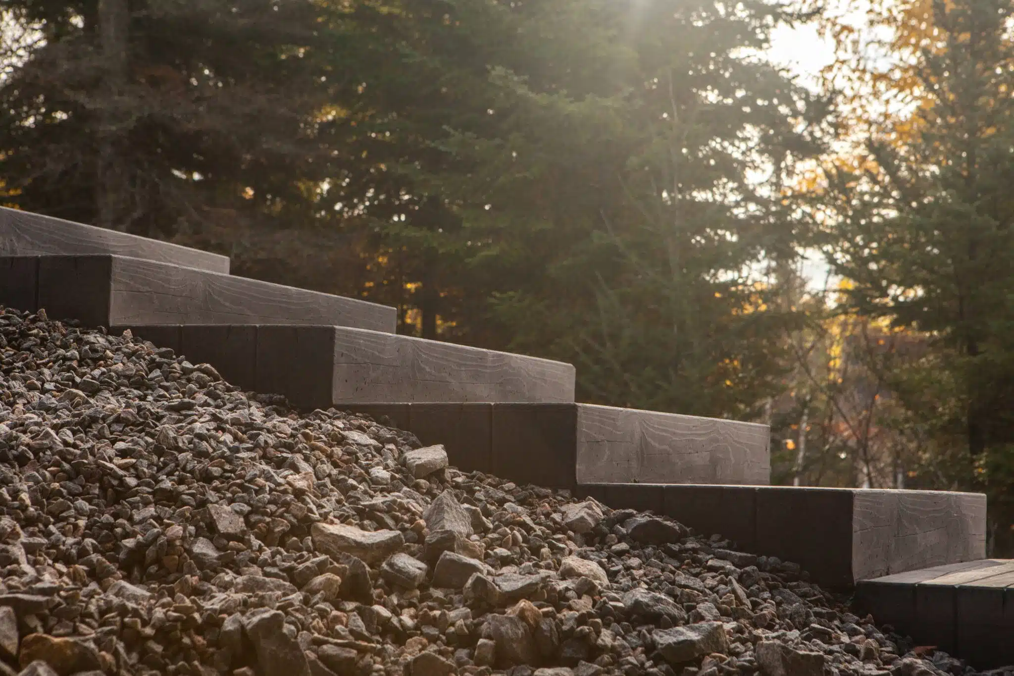 Wooden stairs on a rocky slope leading to a forest