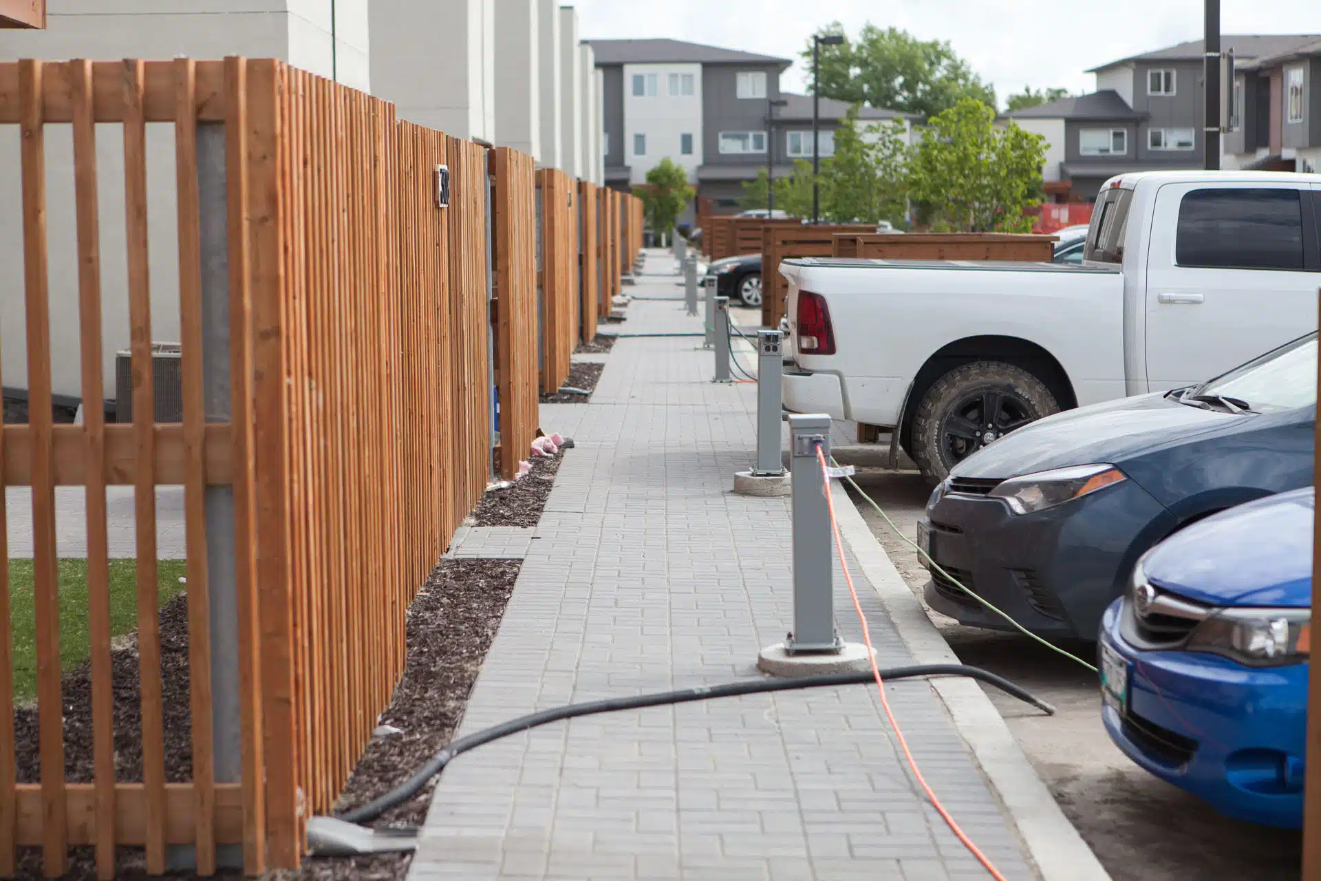 Electric vehicle charging stations on a residential street with cars plugged in