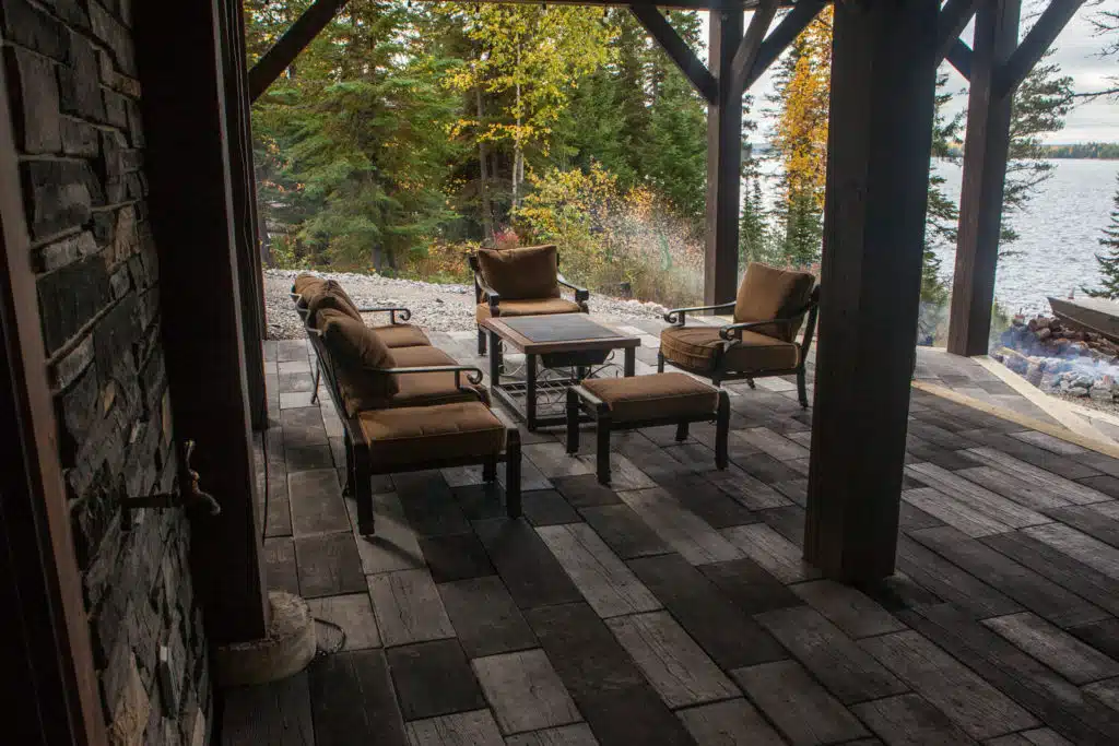 Stone patio at the cabin with outdoor table and chairs.