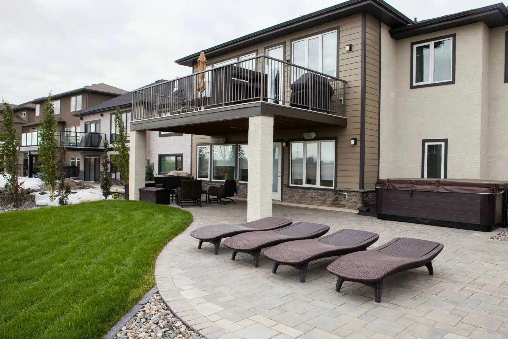 Backyard with patio, hot tub, lounge chairs, and raised deck