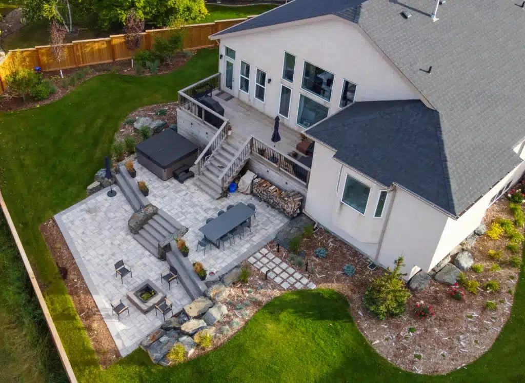 Aerial of landscaped backyard, complete with stone patio & fire pit