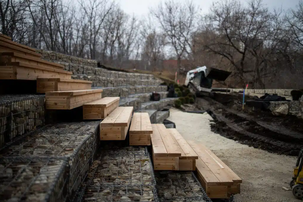 Wooden steps integrated with custom stone feature