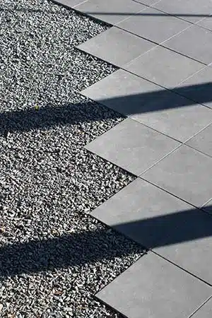 Geometric gray pavers alternate with gravel landscaping