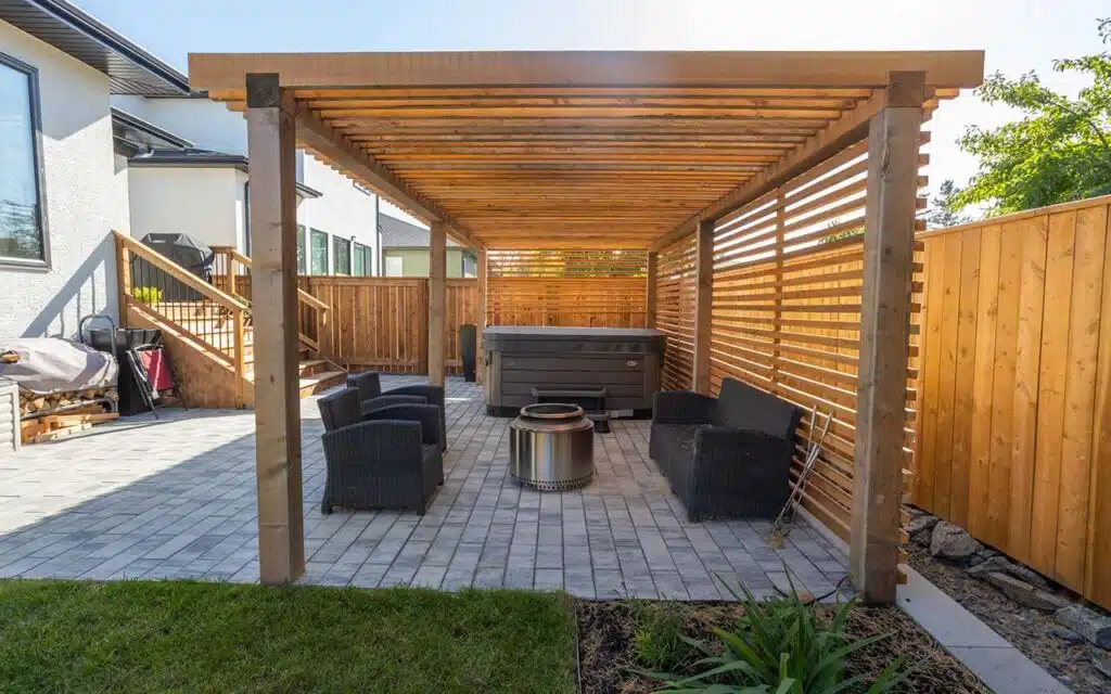 Backyard patio with pergola, hot tub, and seating area