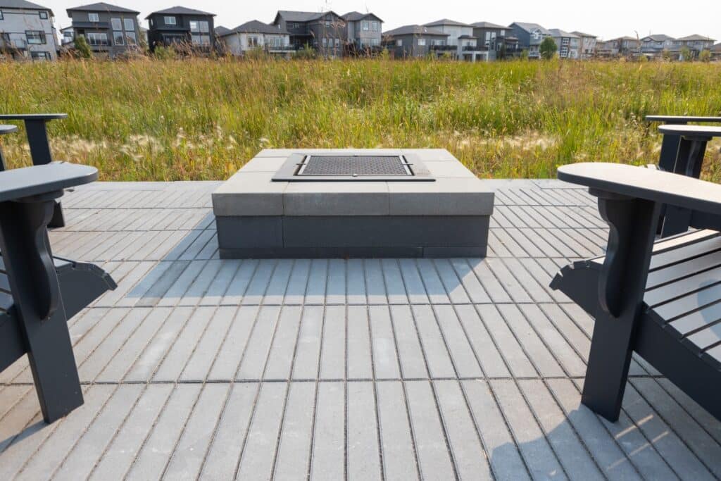 Close up of an outdoor stone fireplace overlooking a field.