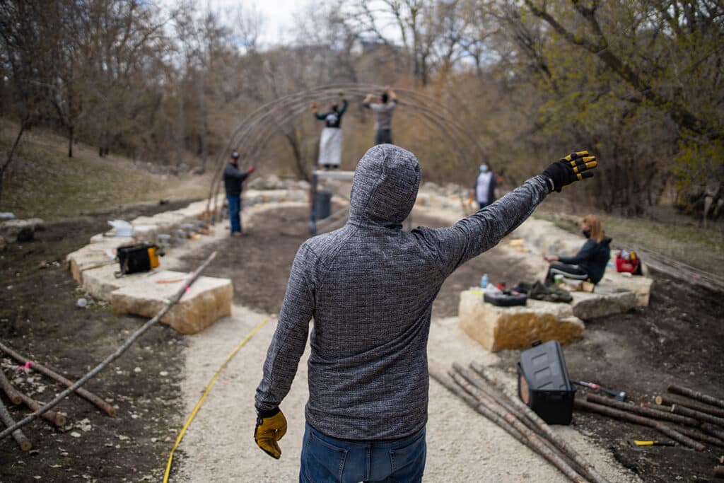 Foreman directing crew on construction site.