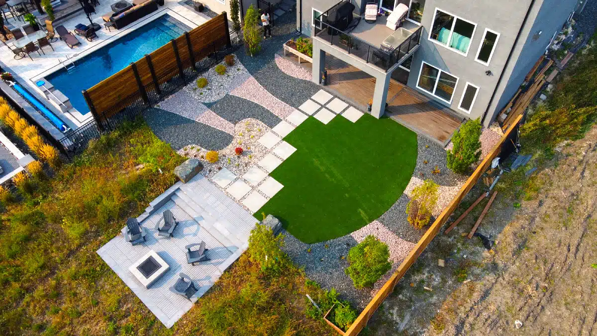 Fully landscaped yard, with stone patio, fire pit and rock garden.