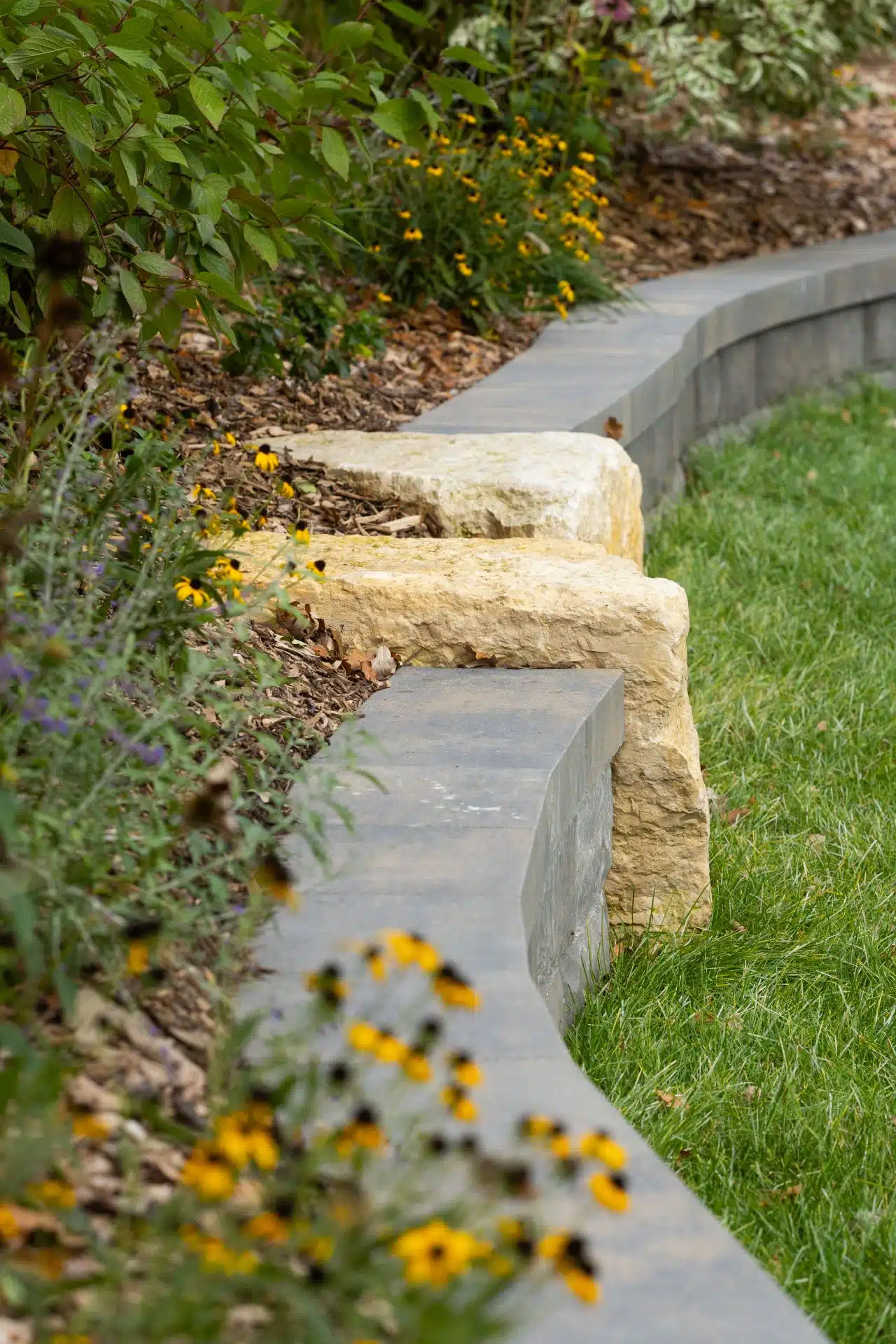curved stone wall and planting bed