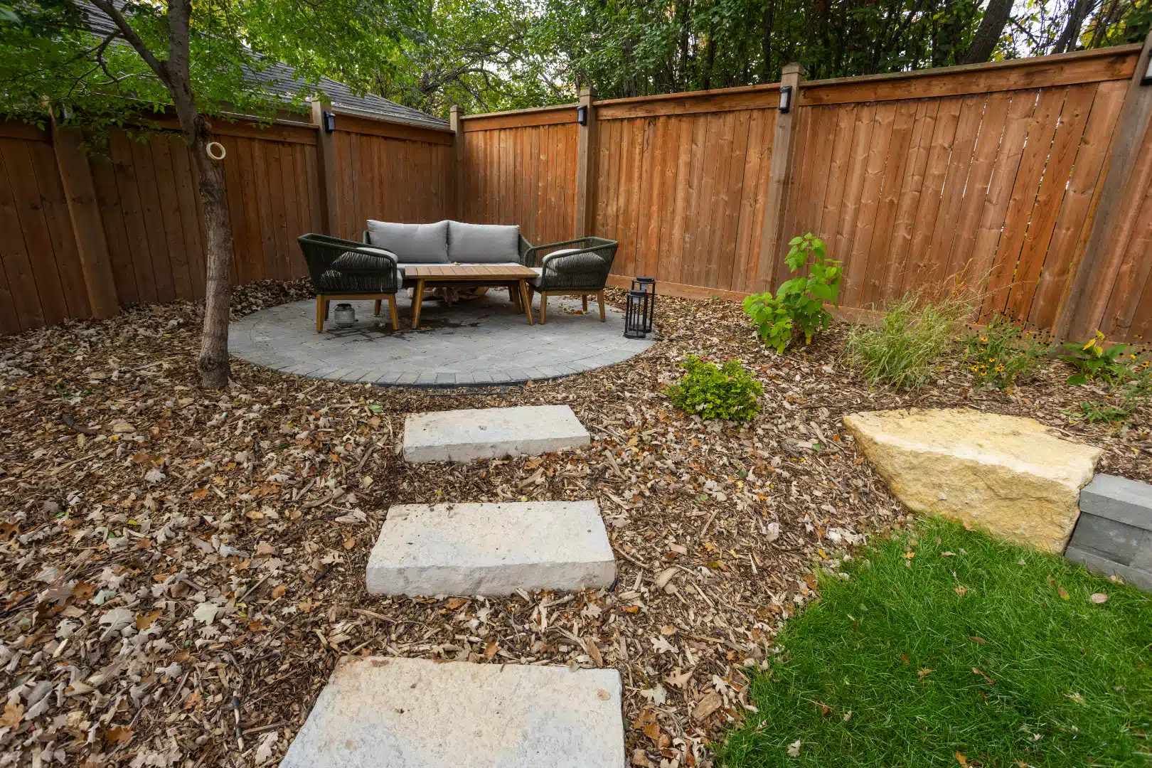 Stone path leading to a cozy circular patio seating area.