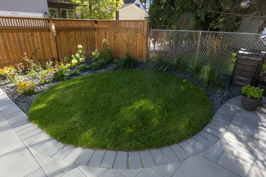 Close view of circular lawn and surrounding stone pavers
