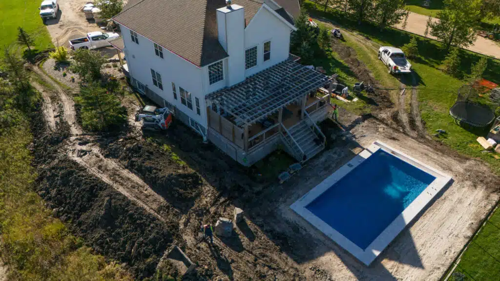 Backyard pool and pergola landscaping in progress.